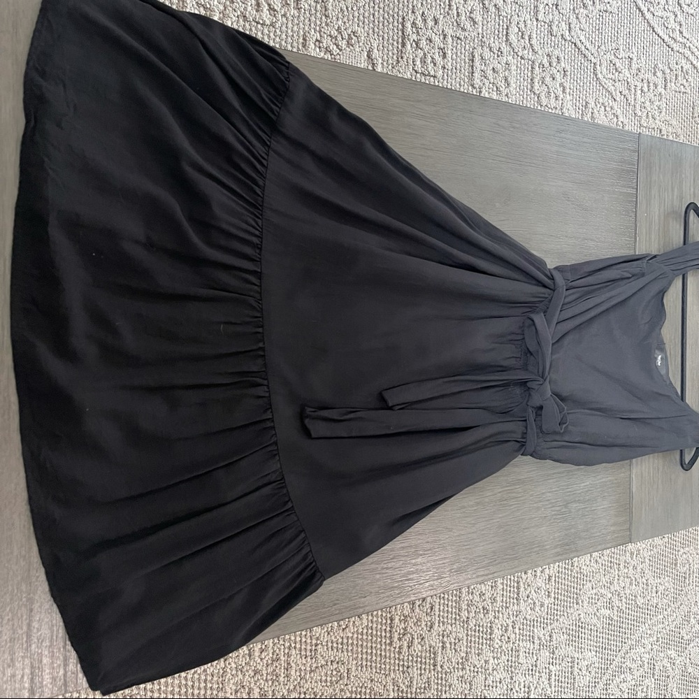 Women’s asymmetrical black dress.